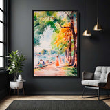 Framed painting of a park scene with people by a lake on a dark wall, with a plant and chair in the foreground.