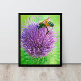 Framed artwork of a bee on a purple flower against a green background.