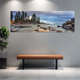 Large wall-mounted canvas print of a beach scene with a brown bench and plant in front.