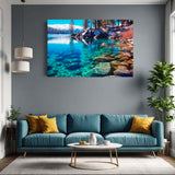 Living room with a large wall-mounted canvas depicting a lake and mountains, a blue sofa, and a plant.