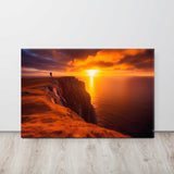 Person standing on a cliff overlooking the ocean at sunset.