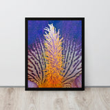 Framed artwork of a vibrant orange coral against a purple background on a wooden floor.